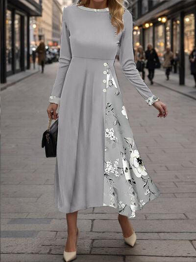 a woman in a gray dress is walking down the street
