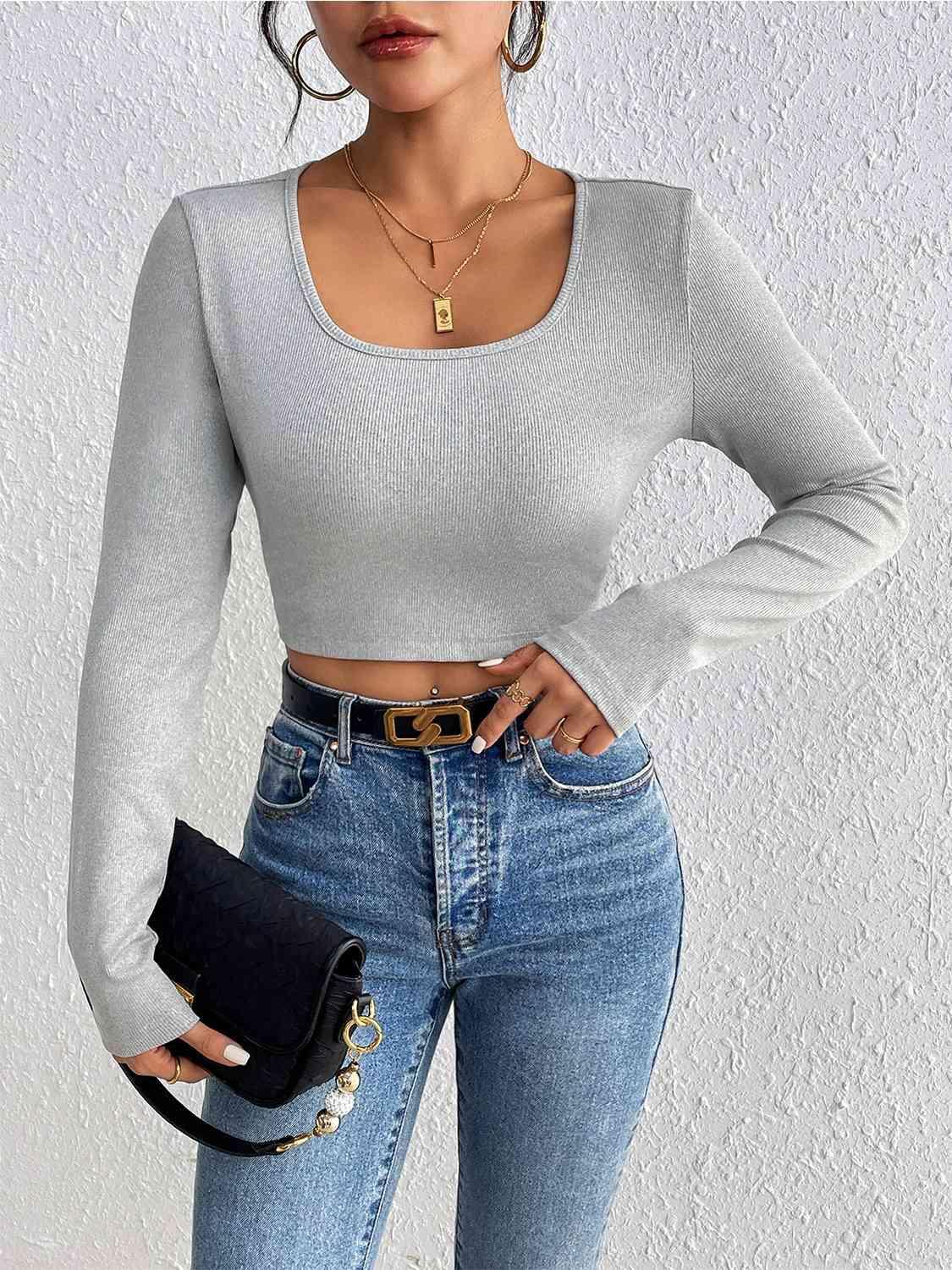 a woman wearing jeans and a crop top