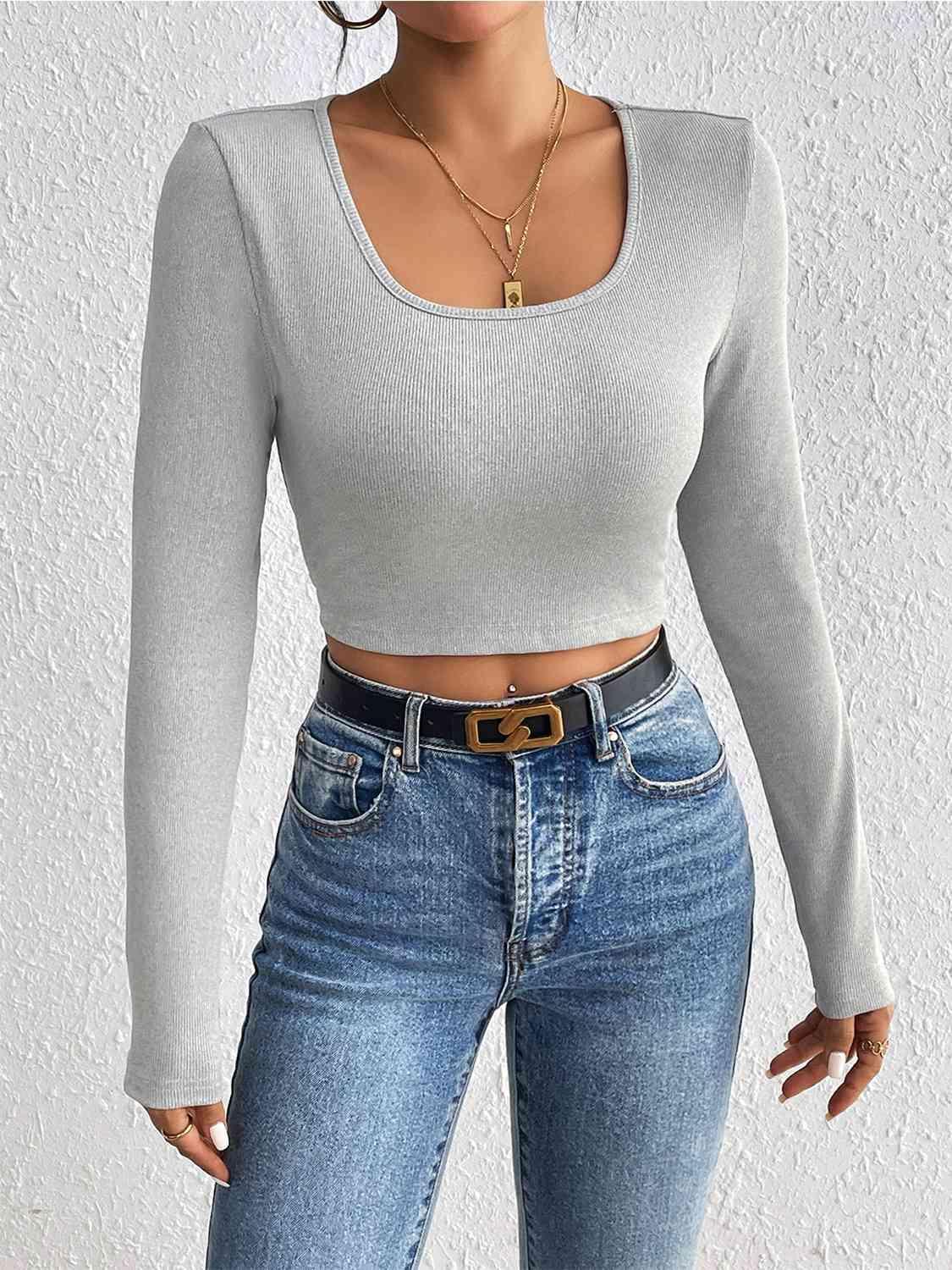 a woman wearing jeans and a crop top