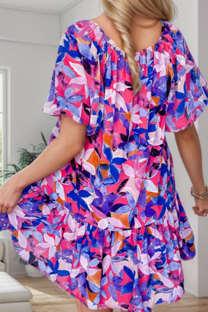 a woman in a colorful dress standing in a room