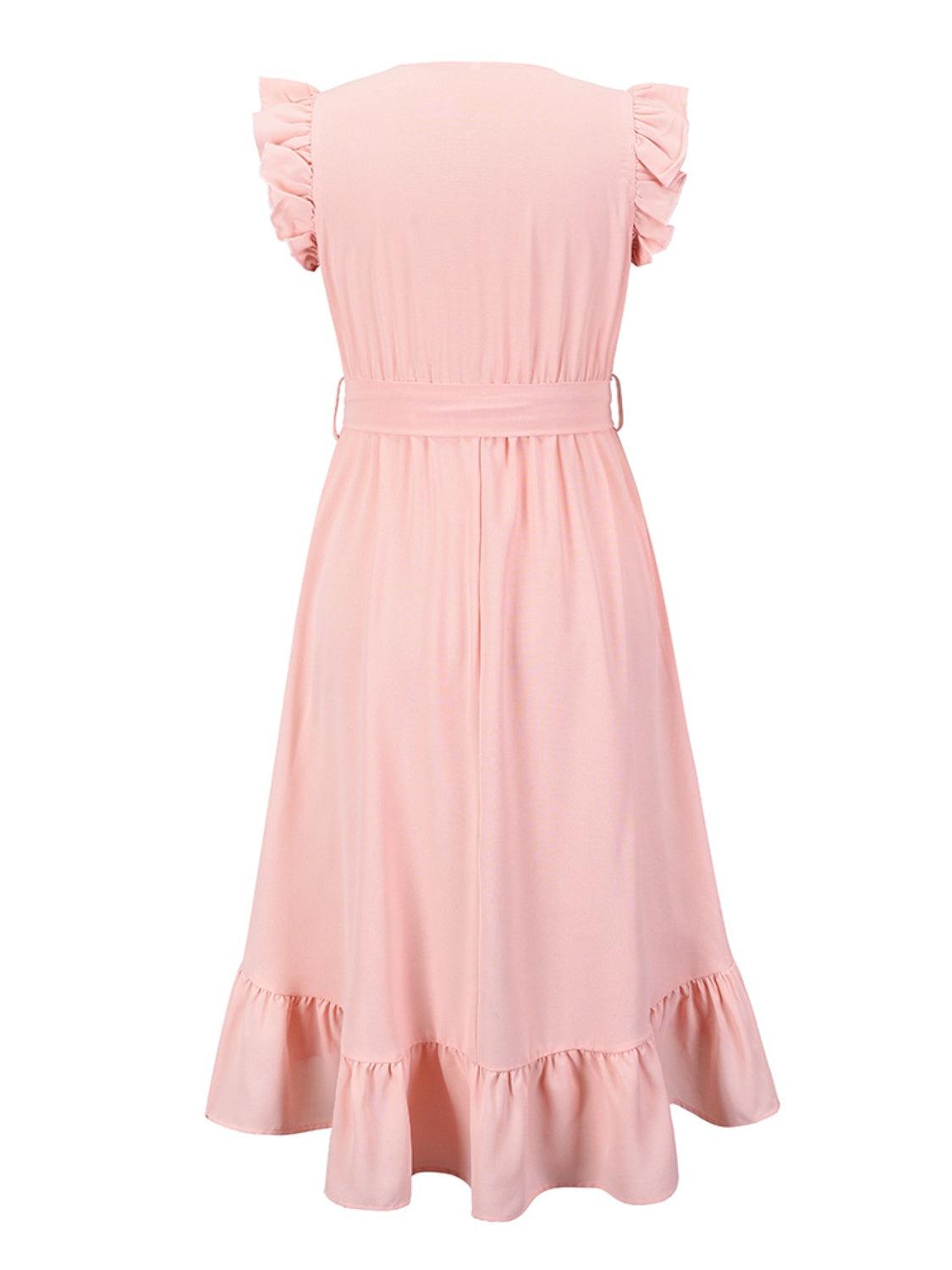 a pink dress with ruffles on the shoulders