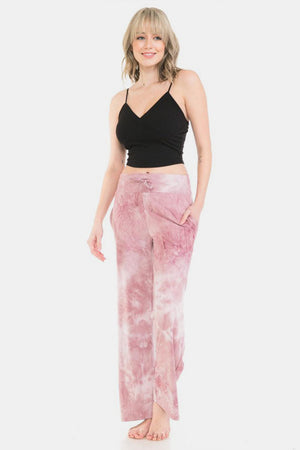 a woman in a black top and pink pants