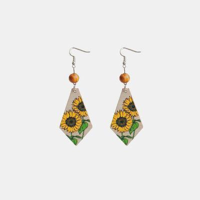a pair of earrings with sunflowers on them