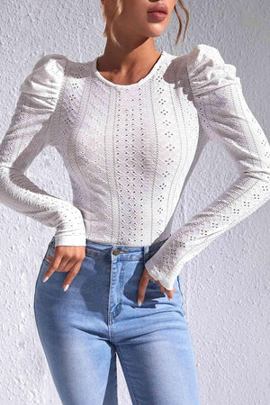 a woman wearing a white sweater and jeans