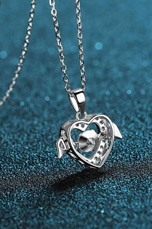 a necklace with a heart and a turtle on it