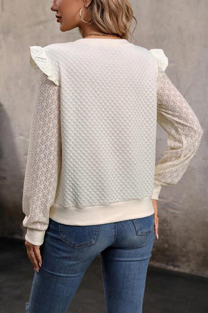 a woman wearing a white sweater and jeans