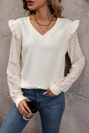 a woman wearing a white sweater and jeans