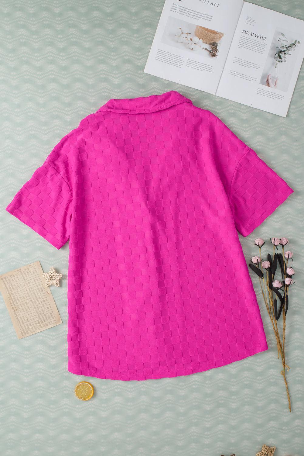 a pink shirt sitting on top of a table