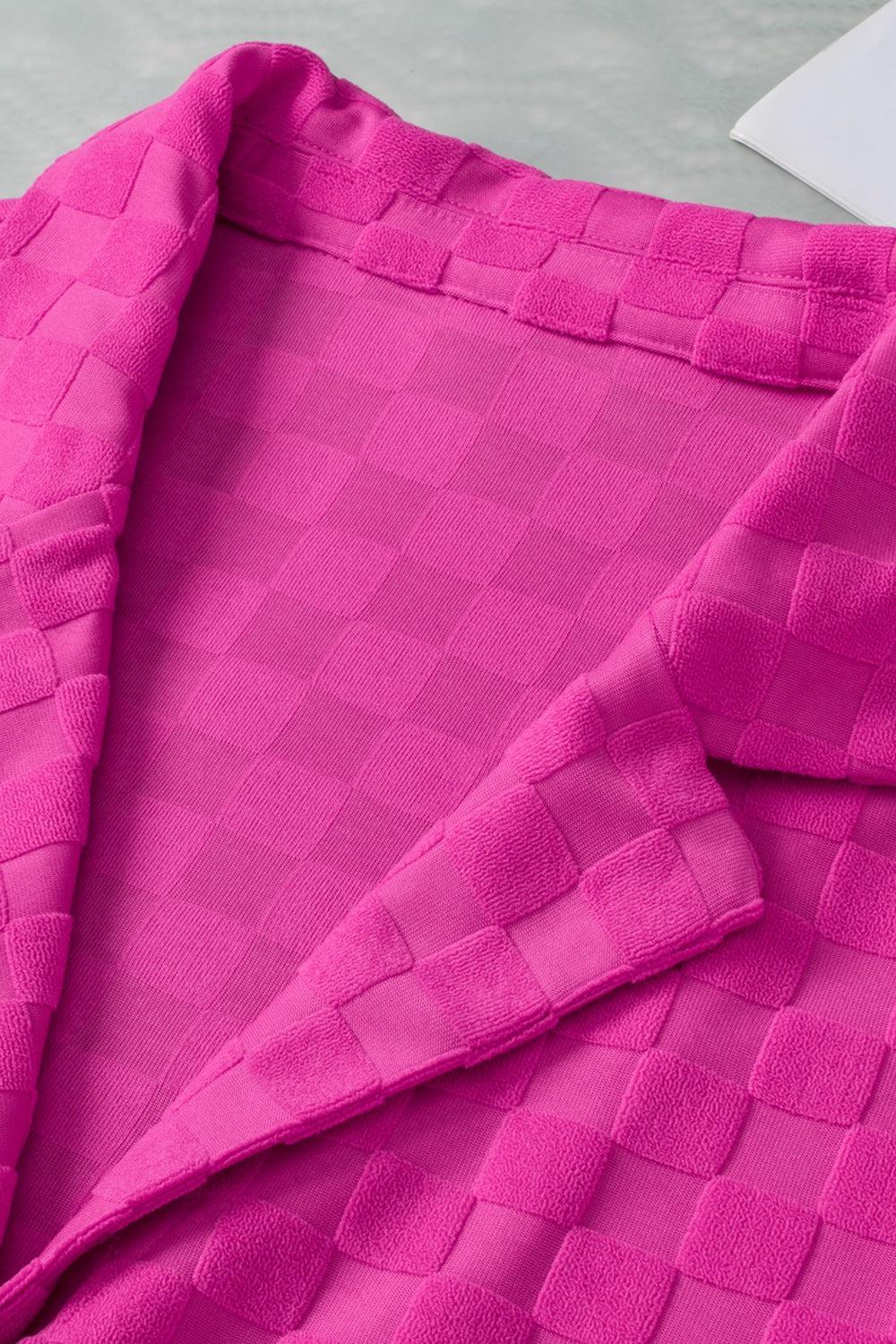 a close up of a pink shirt on a table