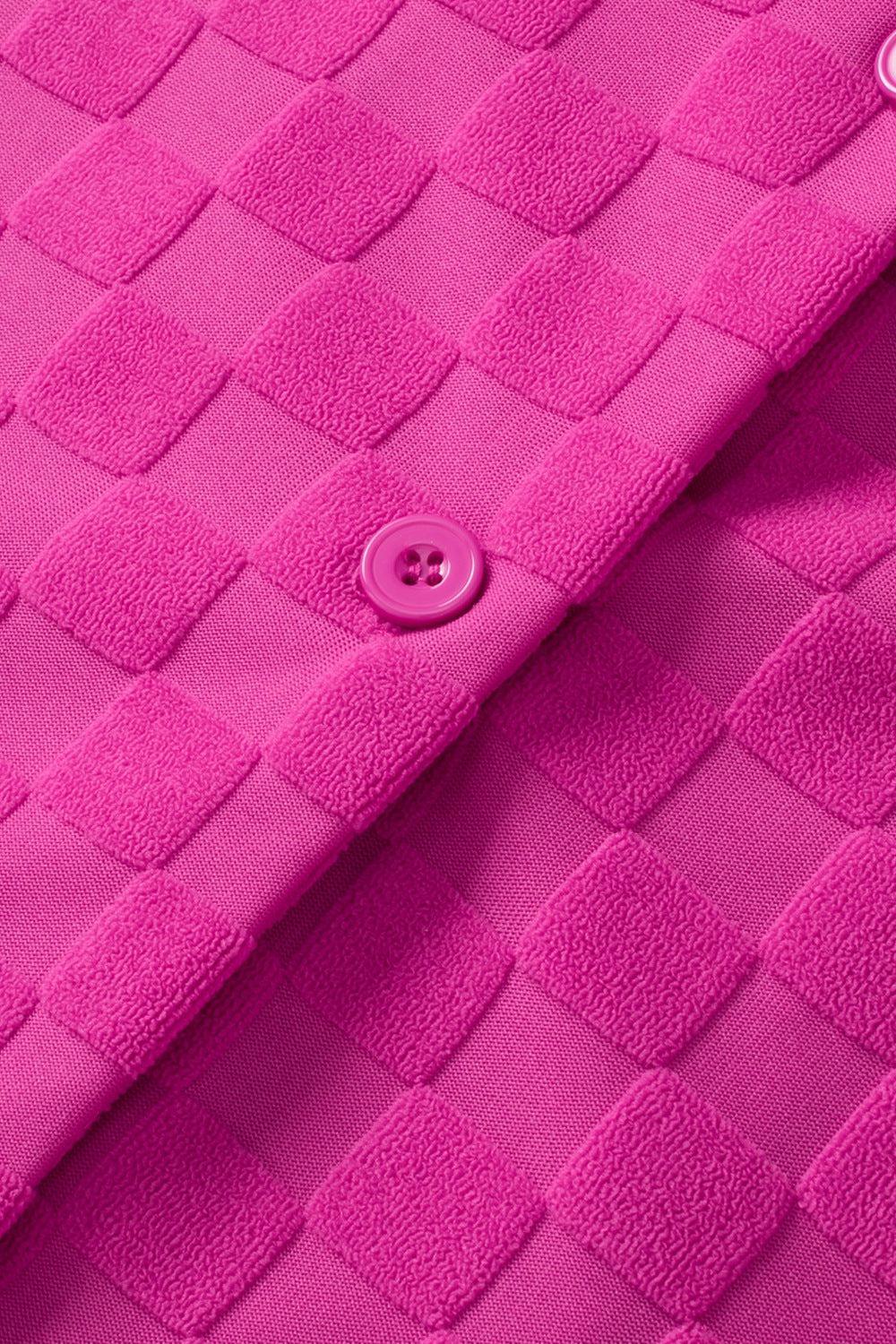 a close up of a pink jacket with buttons