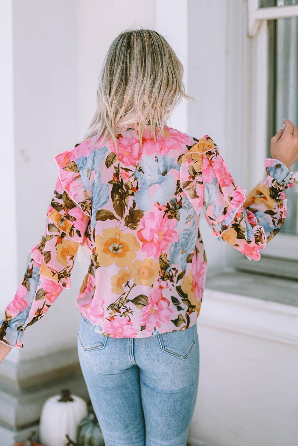 a woman in jeans and a floral shirt