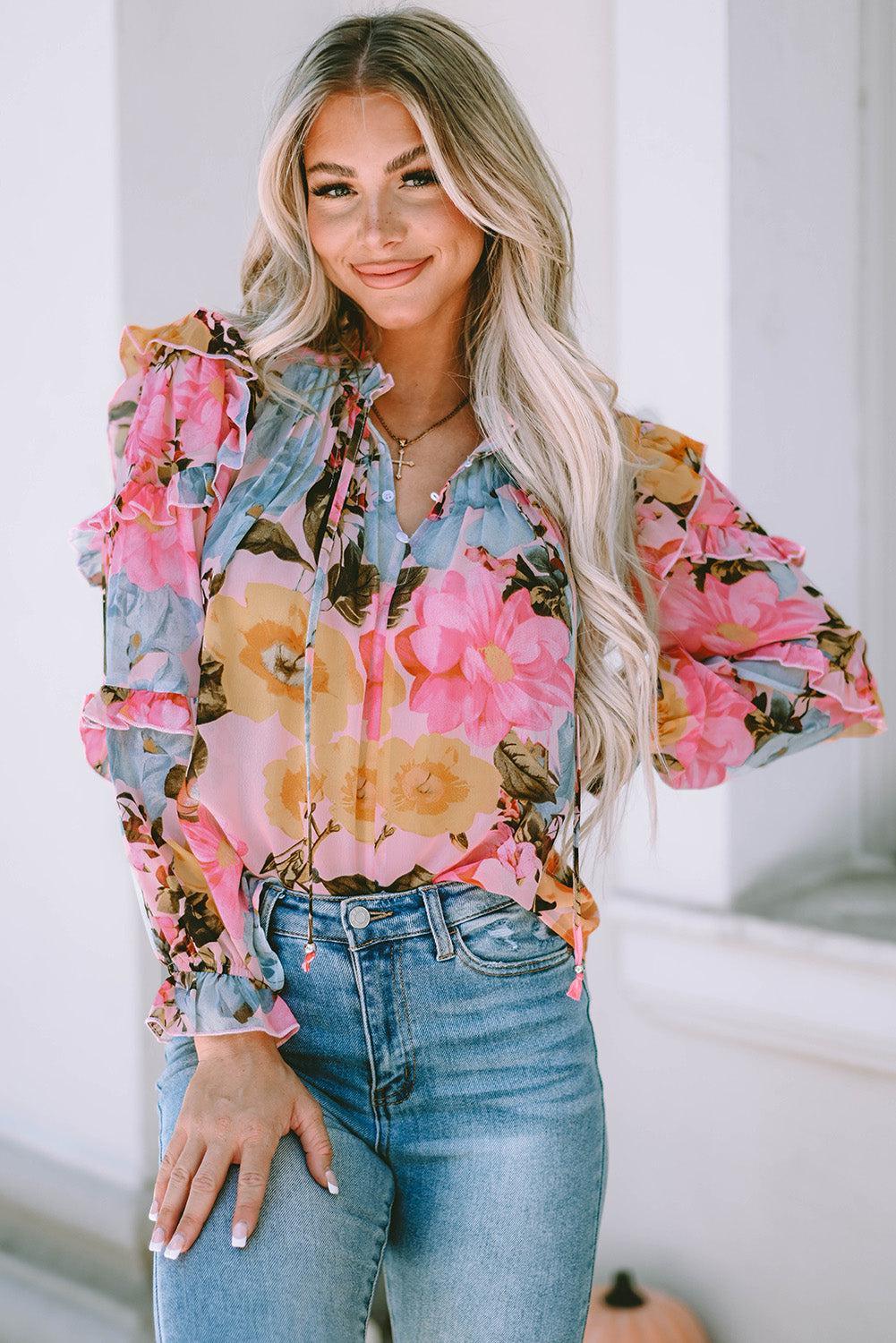 a woman wearing a floral blouse and jeans