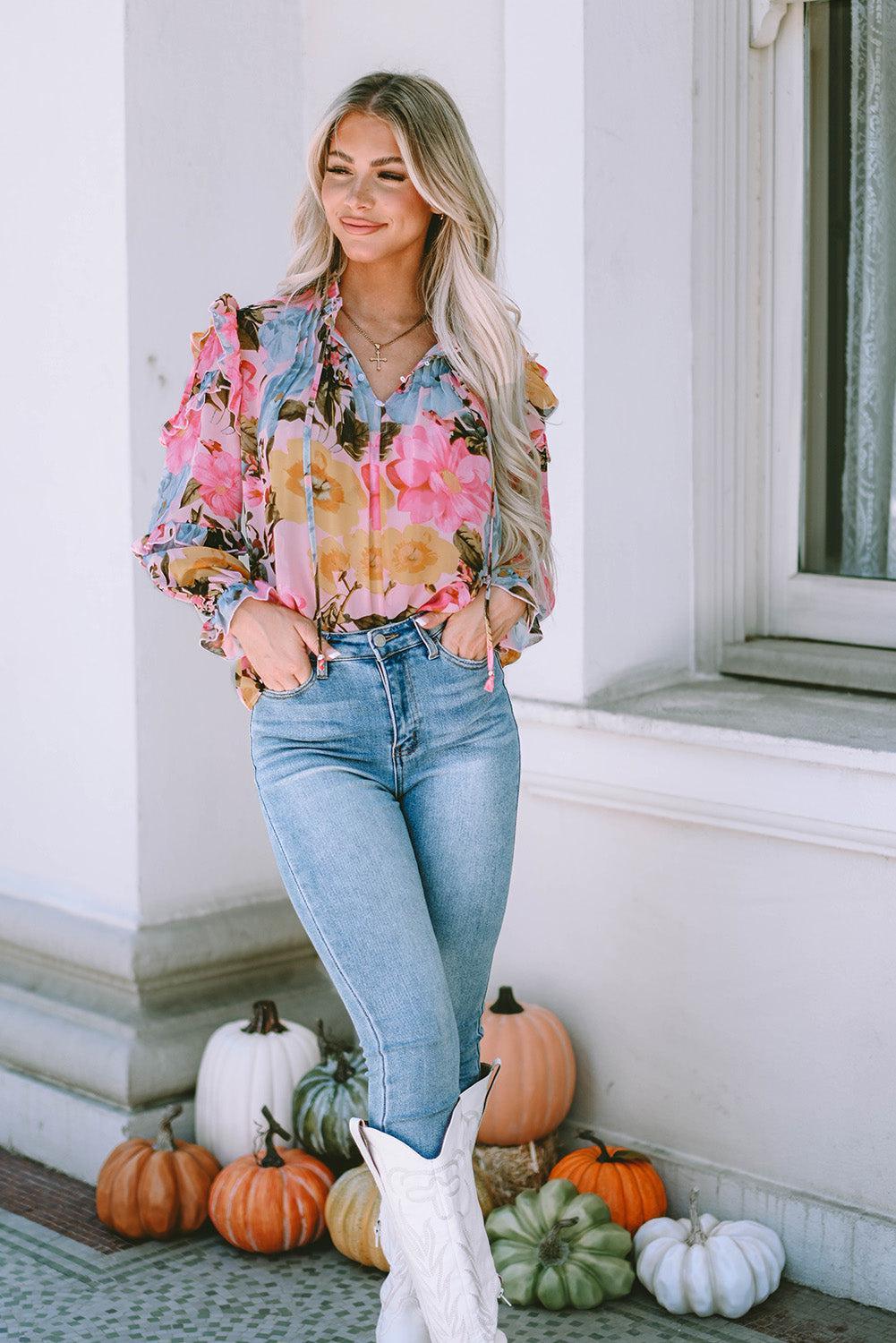 a woman wearing a floral shirt and jeans