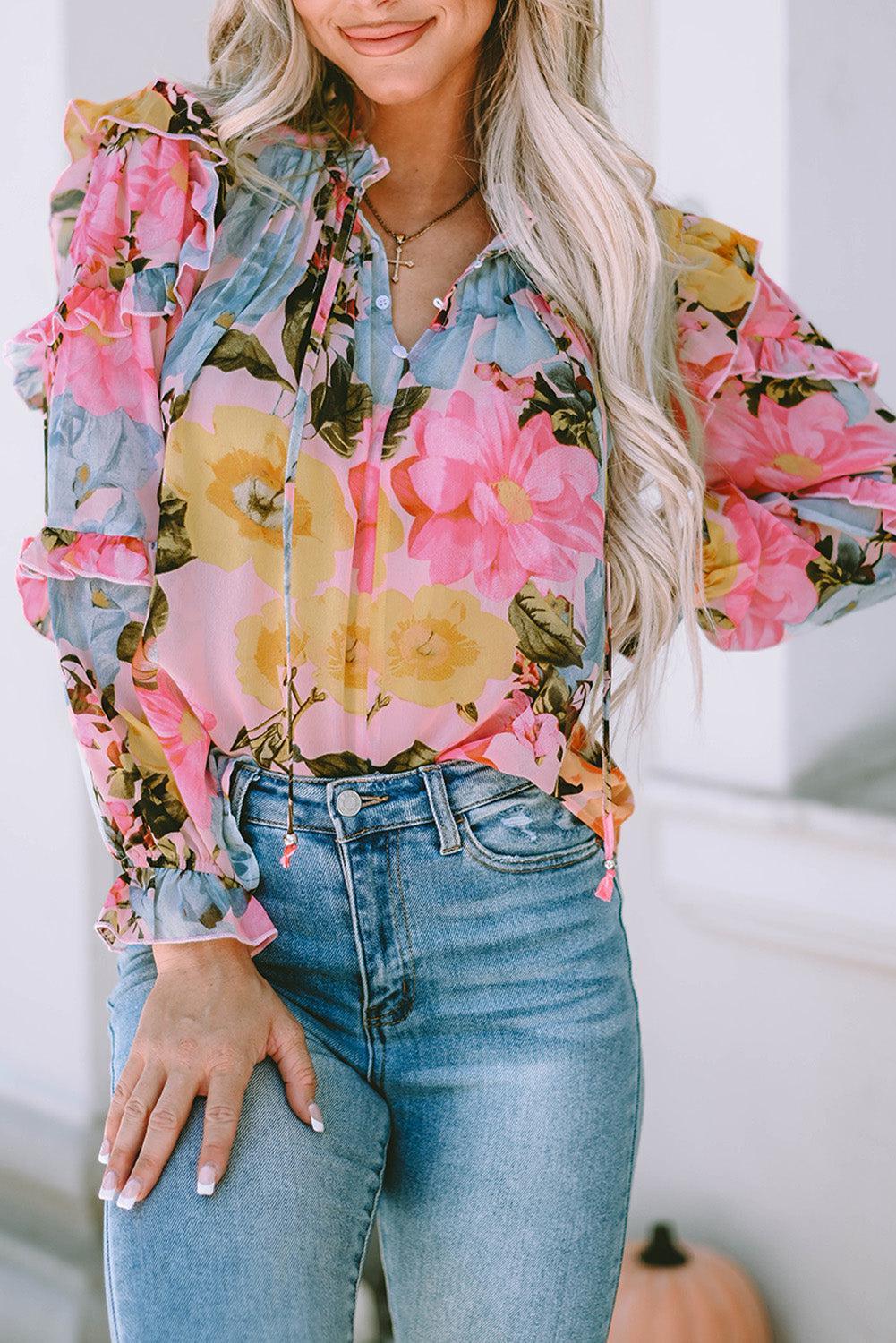 a woman wearing a floral blouse and jeans