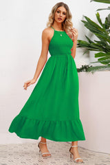 a woman in a green dress posing for a picture