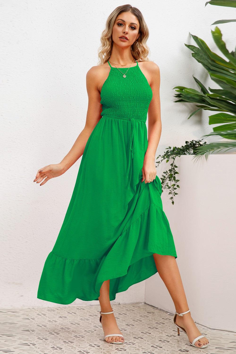 a woman wearing a green dress and heels