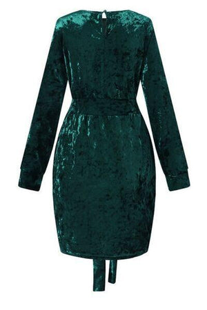 a green velvet dress with long sleeves