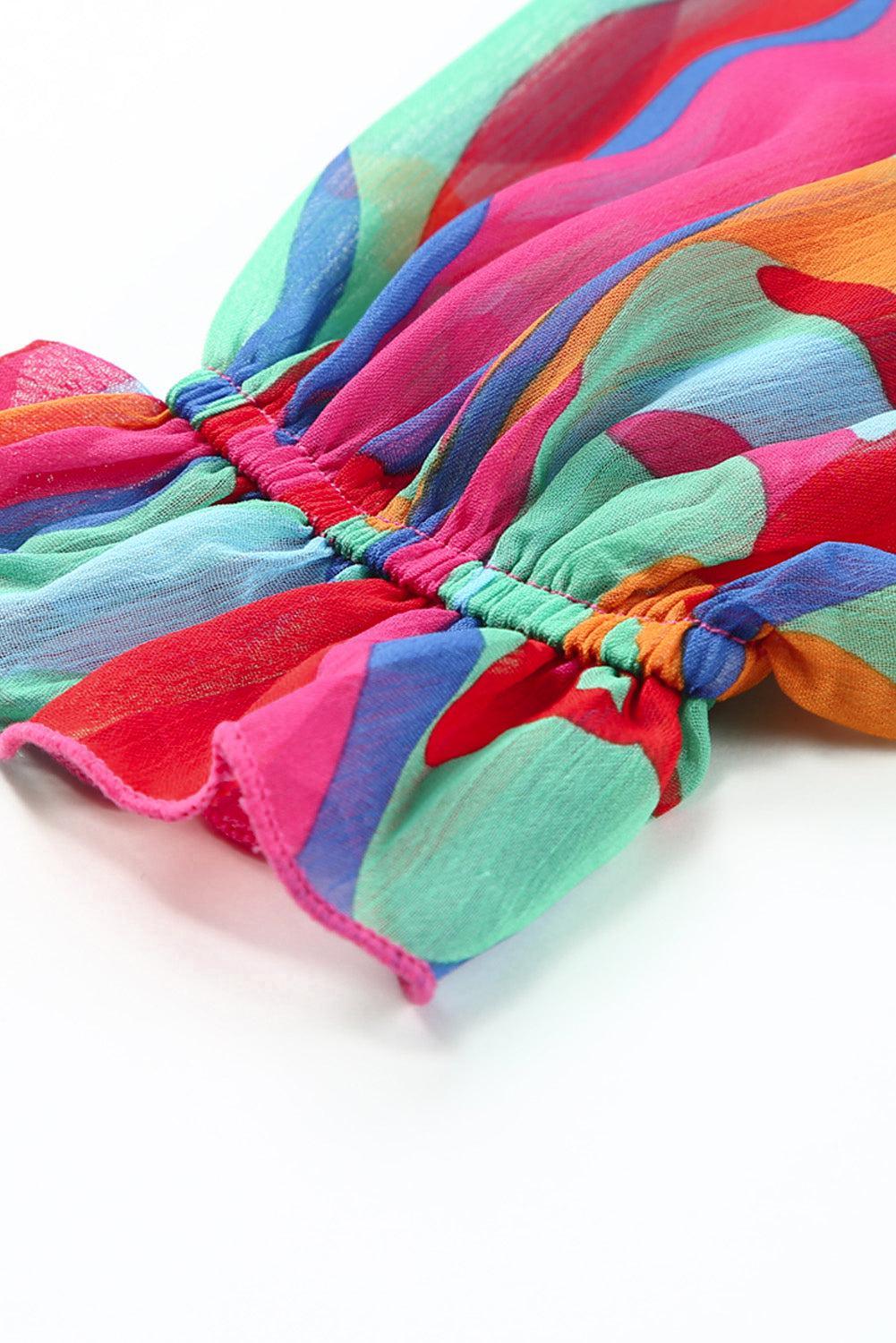 a multicolored scarf laying on top of a white surface