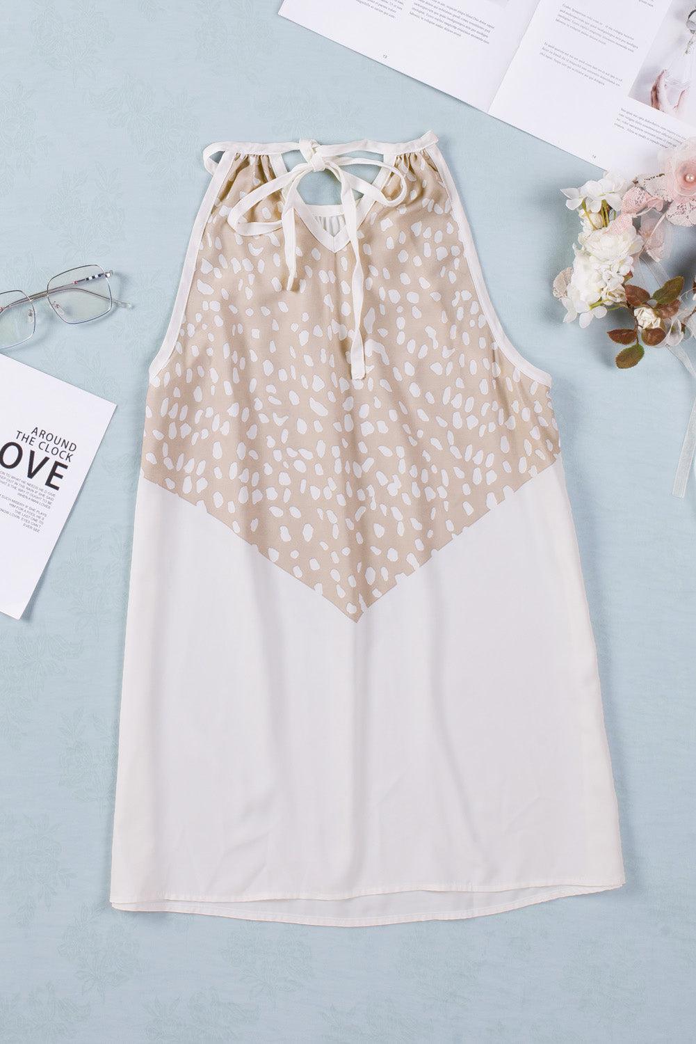 a white and beige dress sitting on top of a table