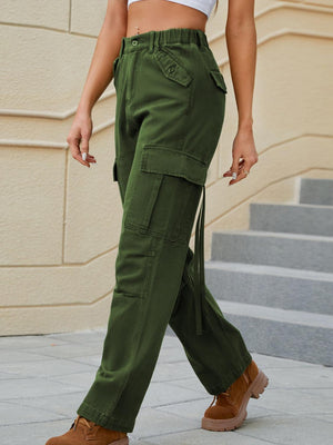 a woman in a white top and green pants