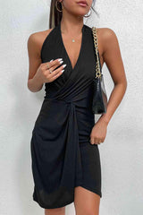 a woman in a black dress holding a cell phone