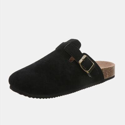 a black shoe with a gold buckle on it