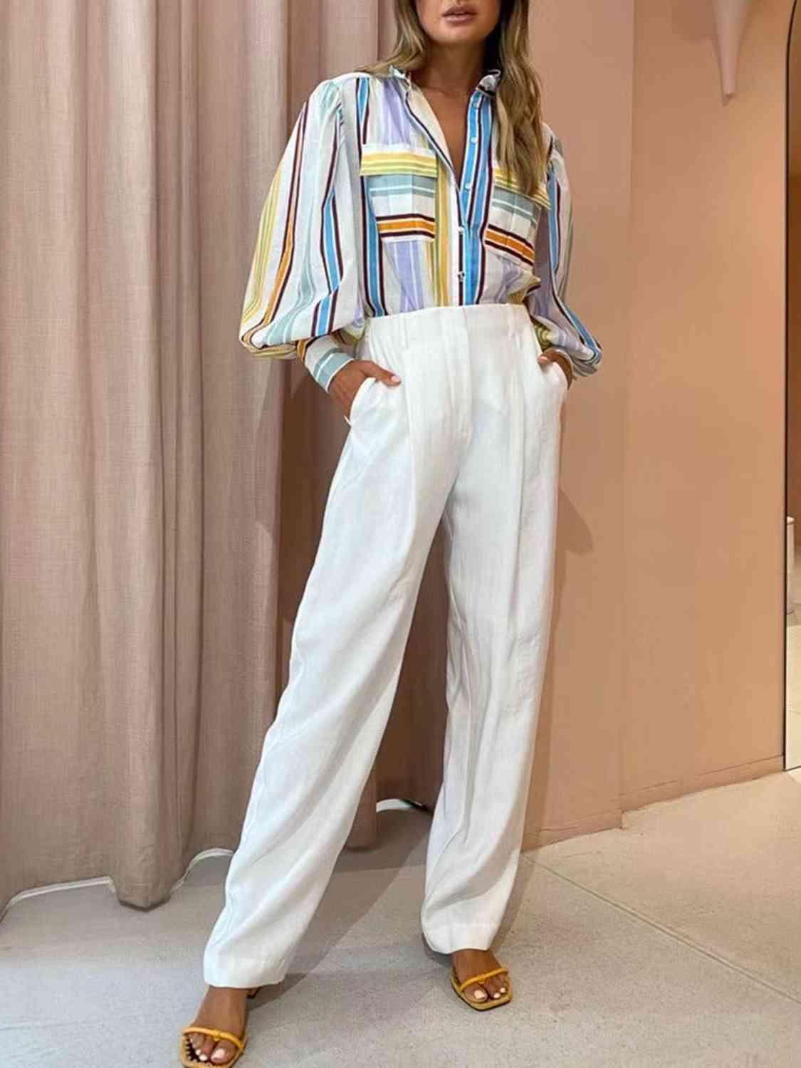 a woman in a striped shirt and white pants