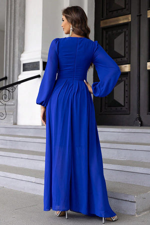 a woman in a blue dress standing on steps