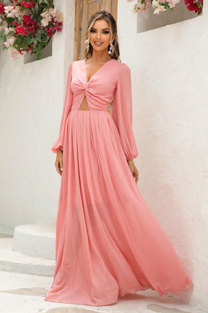 a woman in a long pink dress posing for a picture