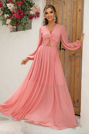 a woman in a long pink dress standing in front of a door