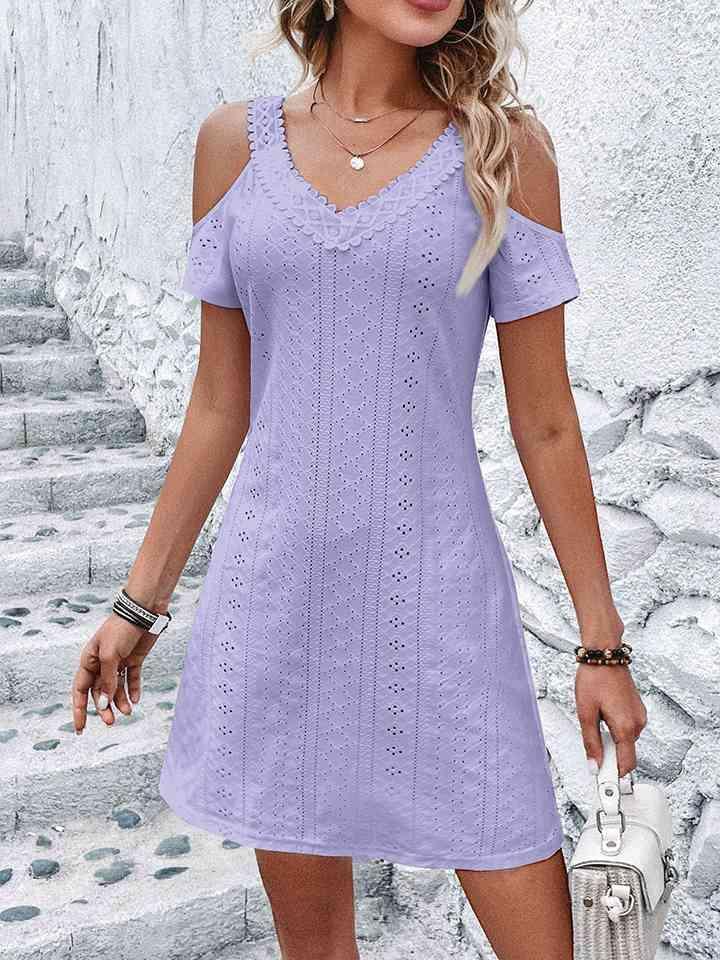 a woman in a short purple dress