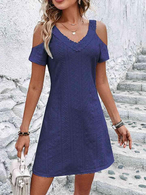 a woman in a blue dress is walking down some steps