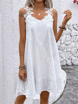 a woman wearing a white dress with white flowers on it