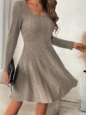 a woman in a gray sweater dress