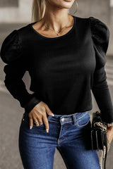 a woman wearing a black top and jeans