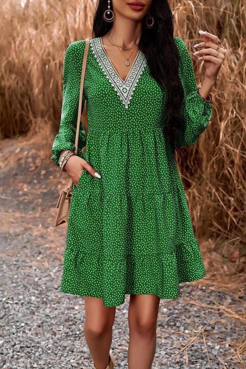 a woman in a green dress is posing for a picture