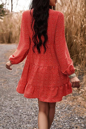 a woman in a red dress walking down a road