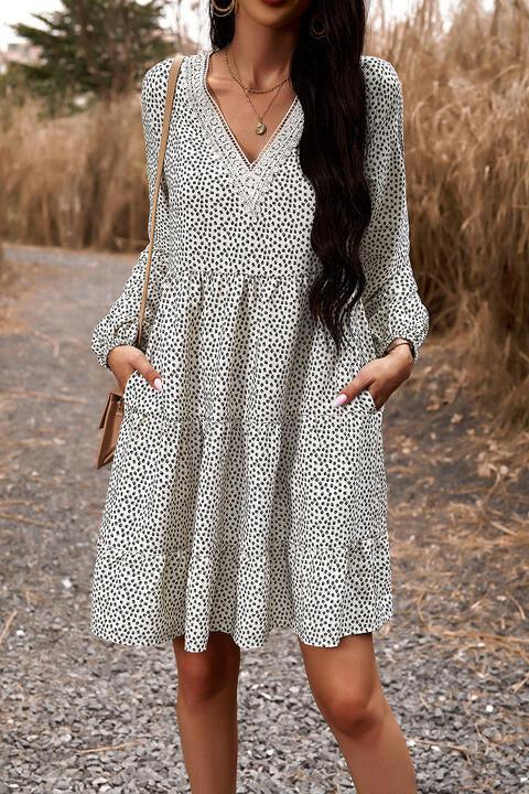 a woman standing on a dirt road wearing a white dress