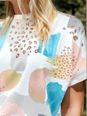 a woman wearing a hat and a colorful shirt