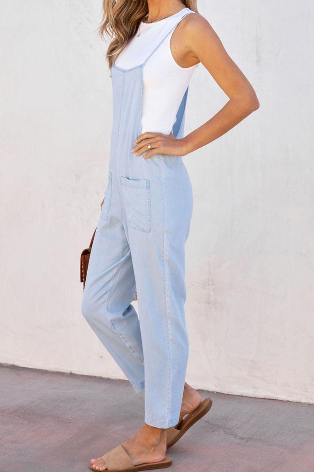 a woman in a white top and blue overalls