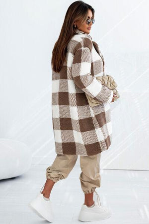 a woman in a brown and white checkered coat