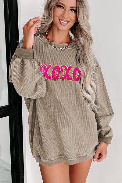 a woman wearing a sweater with the word boo on it