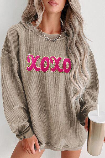 a woman wearing a sweater with the word boo on it