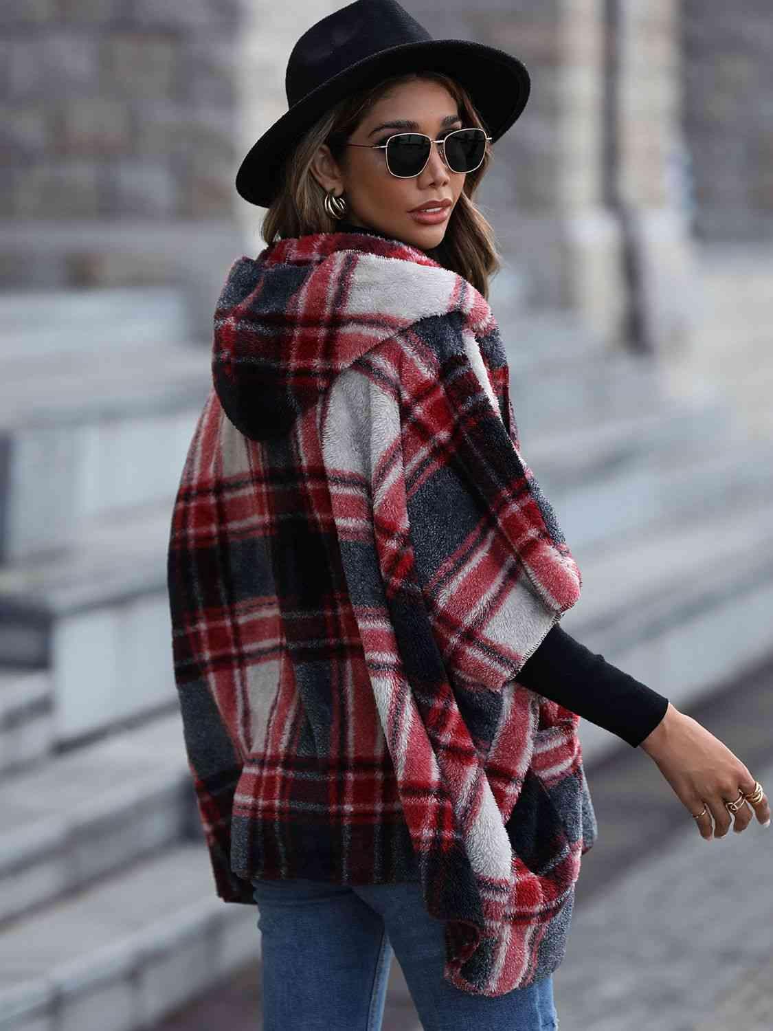 a woman wearing a plaid coat and hat