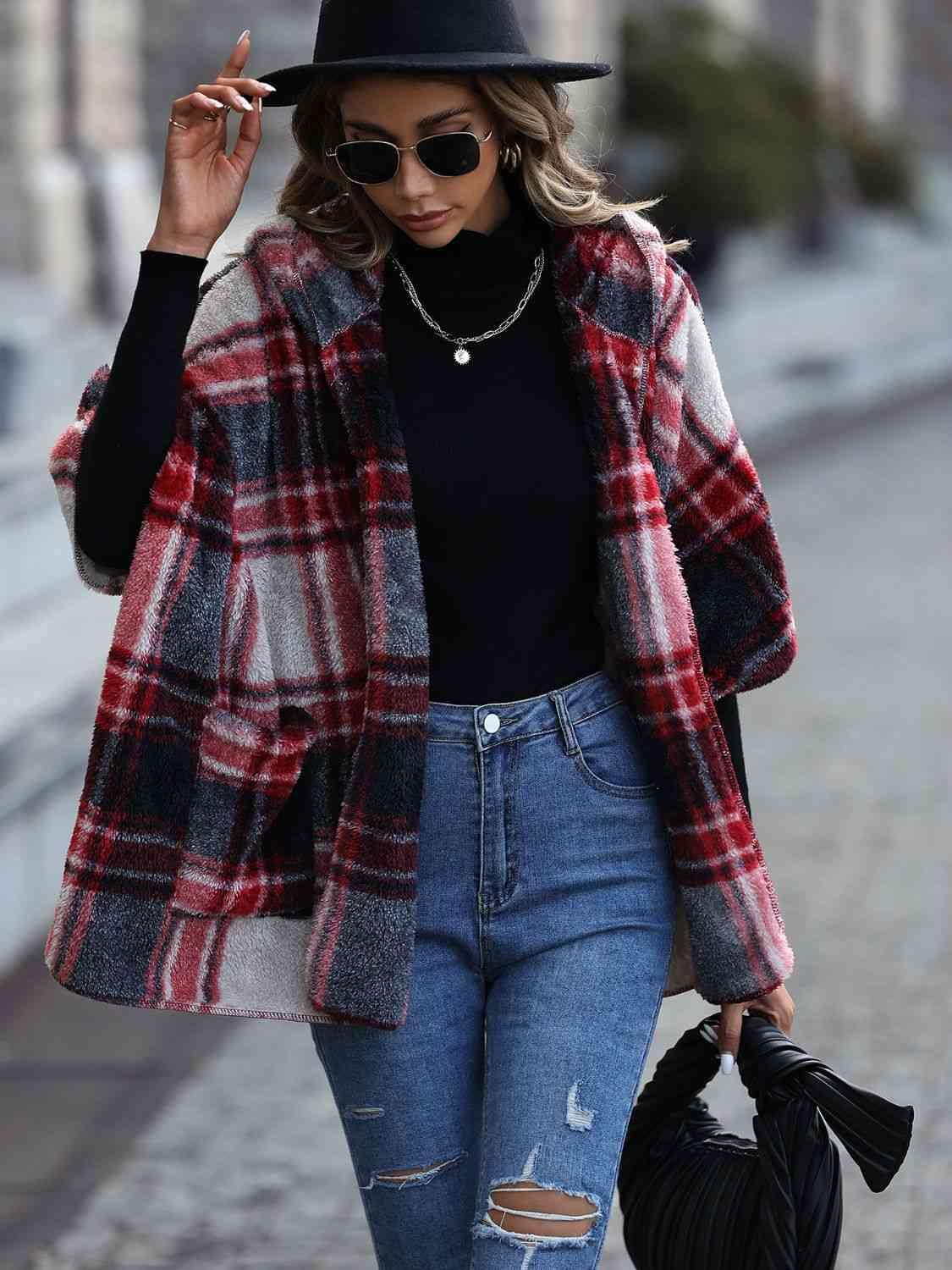 a woman walking down a street wearing a black hat