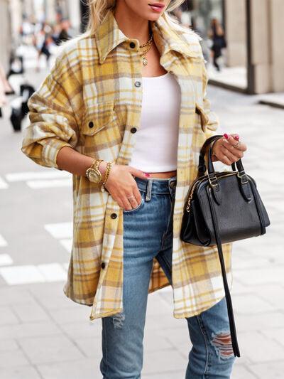 a woman wearing ripped jeans and a plaid coat