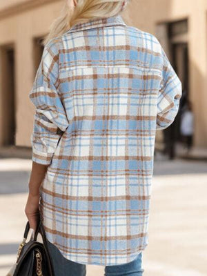 a woman walking down a street carrying a handbag