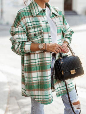a woman in a green and white coat carrying a black handbag