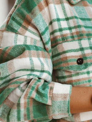 a close up of a person wearing a green and white checkered coat