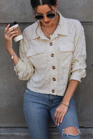 a woman in ripped jeans holding a cup of coffee